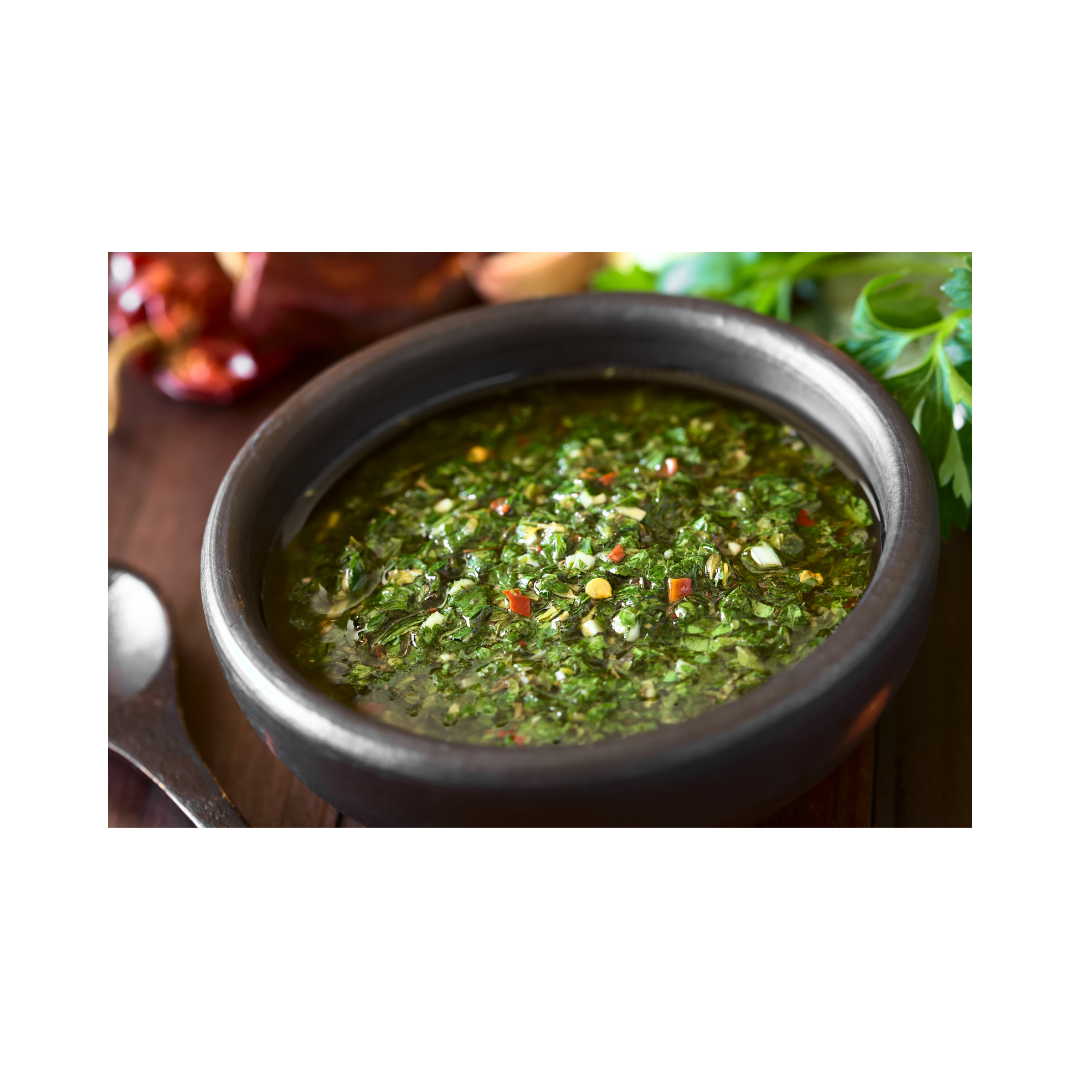 Fresh chimichurri sauce in a black bowl